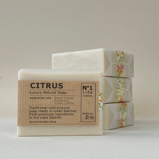 Wrapped Citrus soap bar in front of a stack of packaged bars